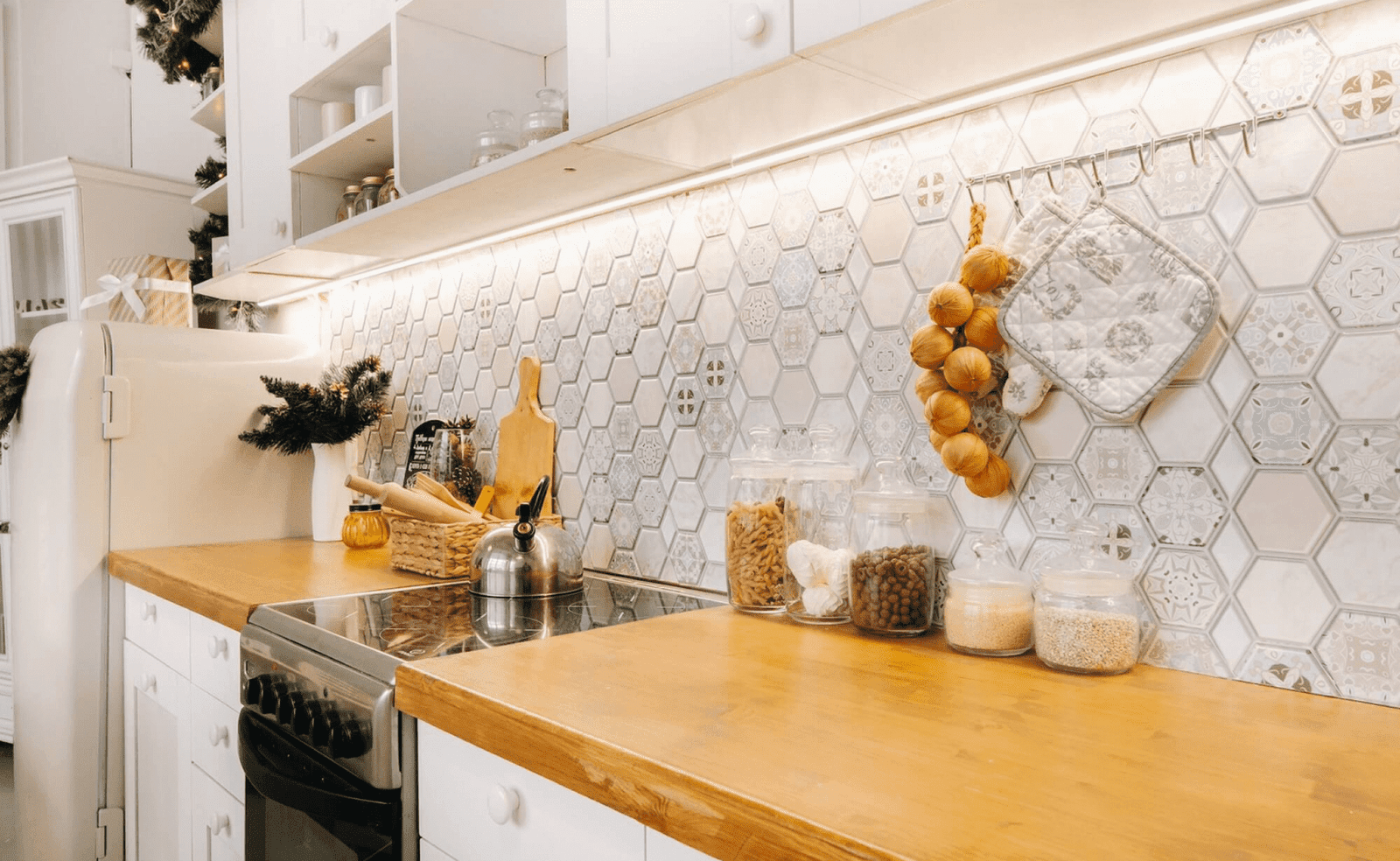 Sterling Heights, MI 14 Well-organized kitchen with wooden countertop, white cabinets, and hexagonal tile backsplash.