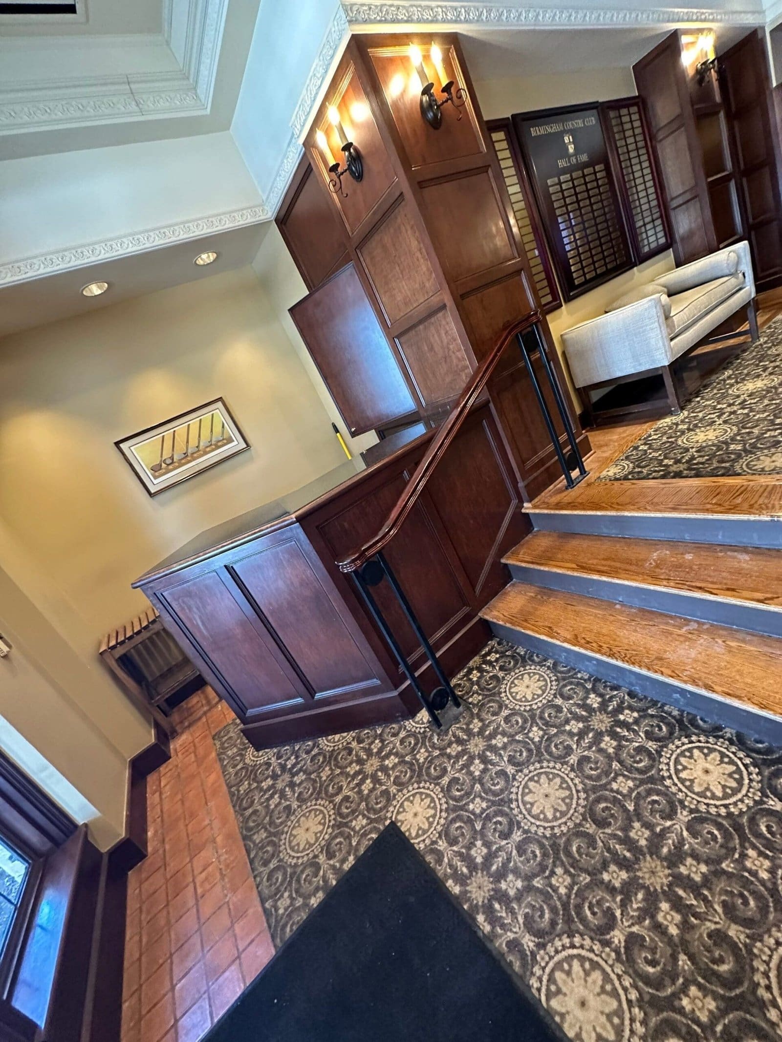 a lobby with a wooden counter and stairs
