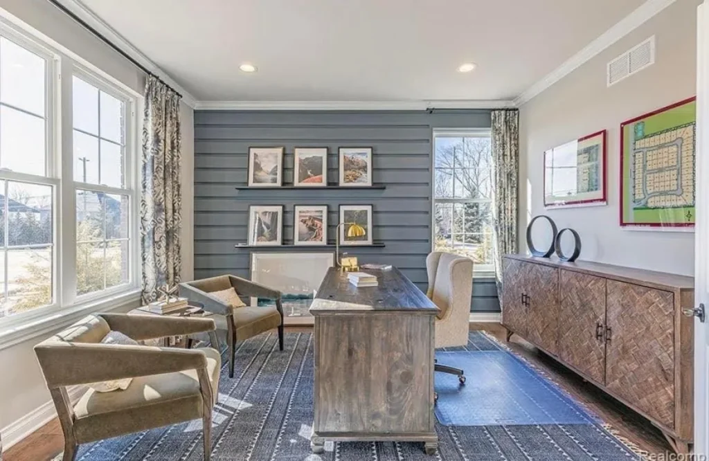 a room with a desk and chairs